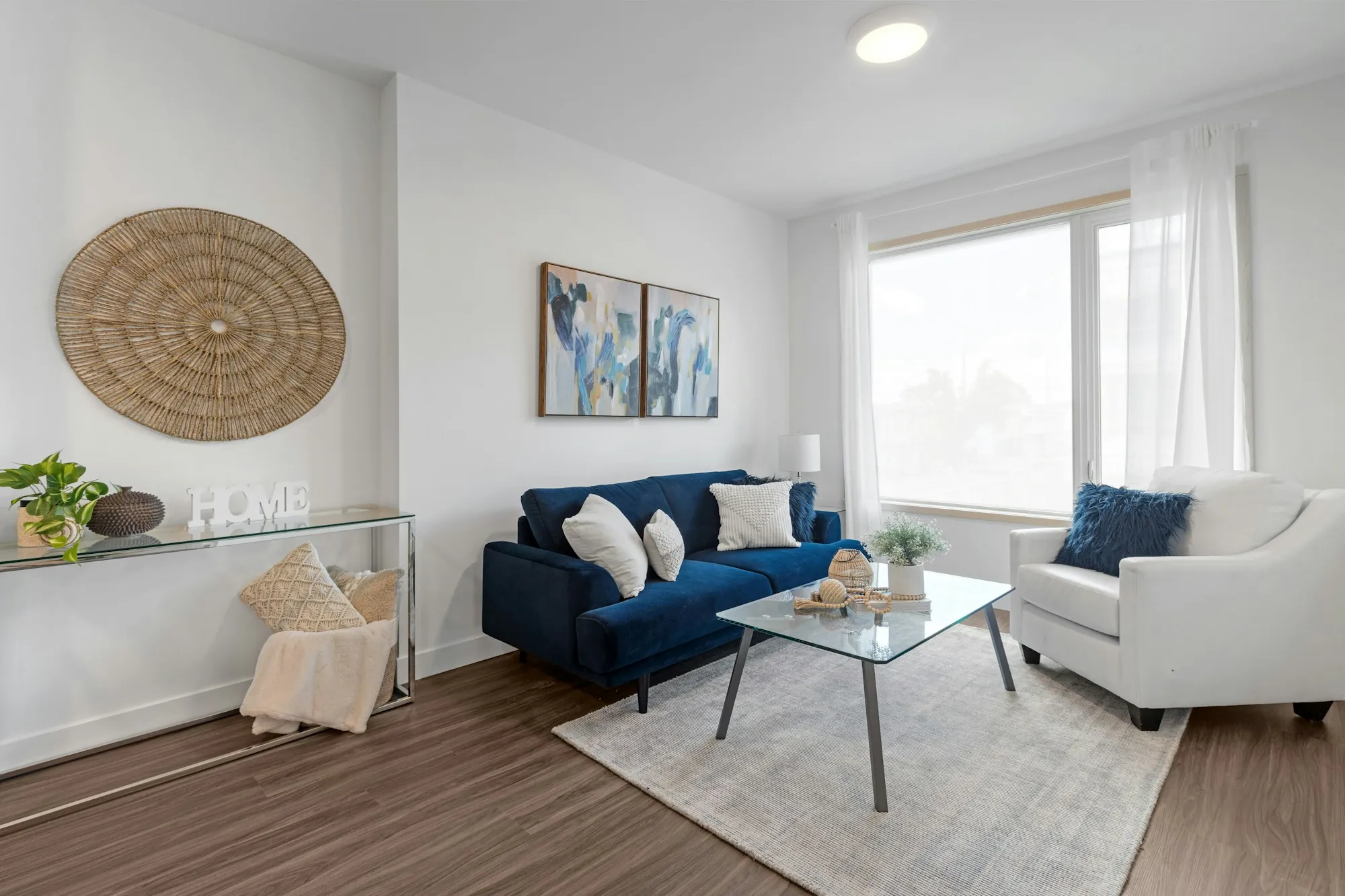 Living room with a navy sofa and white armchairs