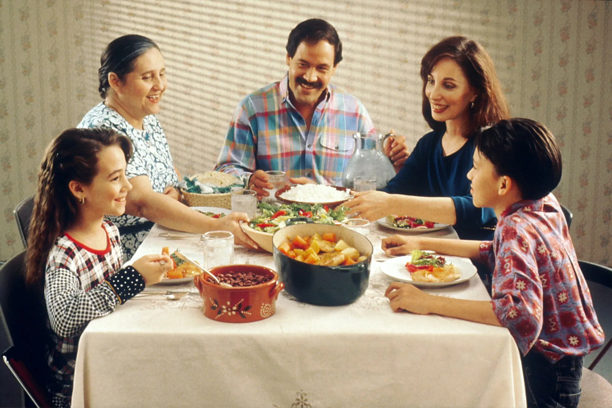Family sharing a meal around a dining table at home
